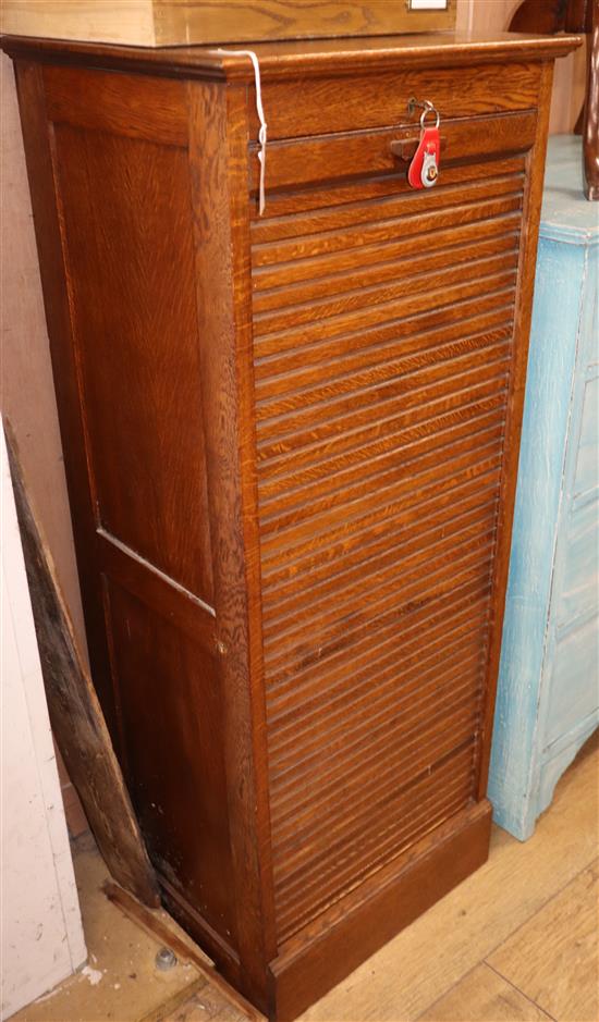 An early 20th century oak filing cabinet, with tambour sliding front H.124cm